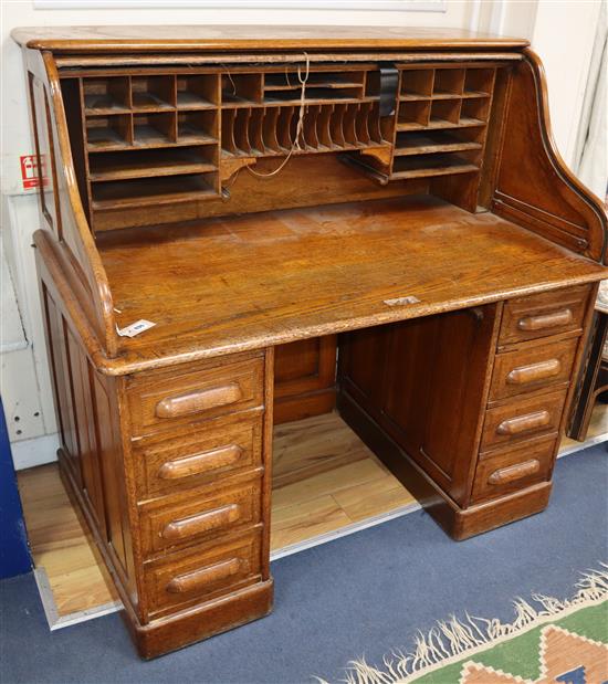 An early 20th century oak roll top desk. W.126cm